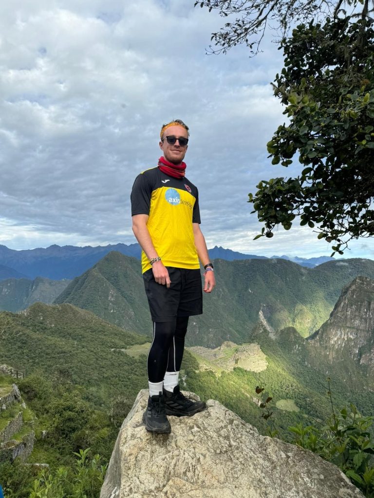 A man wearing a football shirt in Machu Picchu